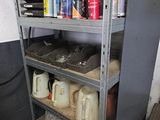 une étagère métallique sur laquelle sont posés des bidons et encore des bidons de peinture