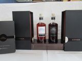 several bottles of liquor are sitting on a table with boxes