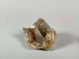 two pieces of gold are sitting on top of a white surface