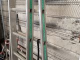 a ladder that is leaning against a wall in a warehouse