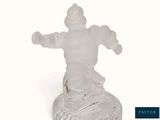 a frosted glass figurine of a man on a skateboard