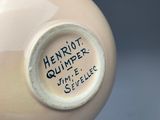 a close up of a vase with a label on it