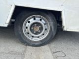 a white truck with a flat tire parked in a parking lot