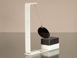 a black and white object sitting on a glass table