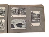 an old photo of a book opened to show pictures of a lake