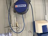 a blue and white sign on the wall of a garage
