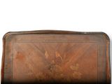an old wooden tray with a floral design on it