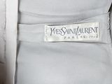 the back of a woman ' s white dress with a white label on it