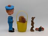 toy figurines of a man and a dog in a basket with a toy car
