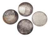 four different types of silver coins on a white background