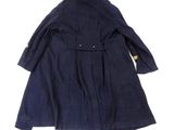 the back of a blue coat with a yellow button on it