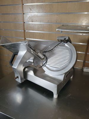 an image of a meat slicer sitting on a counter