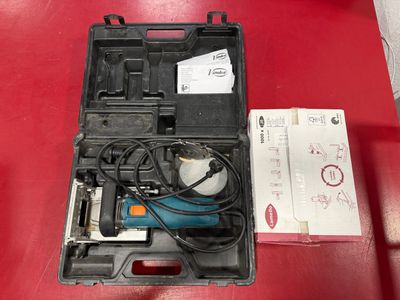 a tool in a case on a red table
