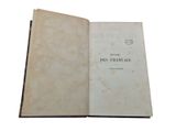 an open book on a white surface with a black border