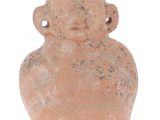 a clay vase with a face on it on a white surface
