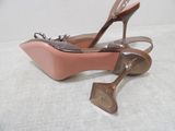 pair of nude colored high heeled shoes sitting on top of a white surface