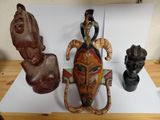 a wooden sculpture of a man riding a horse next to a statue of a man on a horse