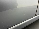 a close up of a car ' s door handle with a sticker on it