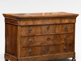an antique chest of drawers with a wooden top
