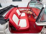 a red and white car with a red seat and a black bag