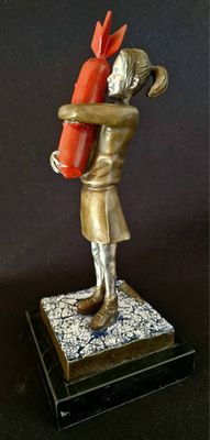 bronze statue of a woman holding a fire extinguisor on a marble base