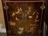 a cabinet that has a bird and flowers design on it