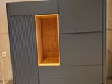 a grey cabinet with a wooden shelf in the middle