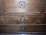 an image of a wooden chest of drawers in a room