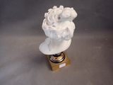 a white statue of a woman with a bird on her head