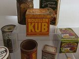 many different types of tins on display in a glass case