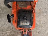 an overhead view of a chainsaw on a concrete floor