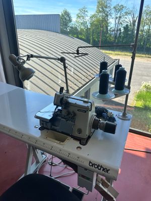 a sewing machine sitting on a table in front of a window