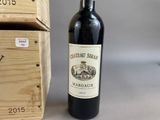 a bottle of wine sitting next to a wooden box