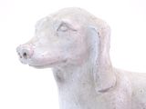 a statue of a dog that is sitting on a table