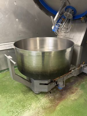 a large metal bowl that is on a stand