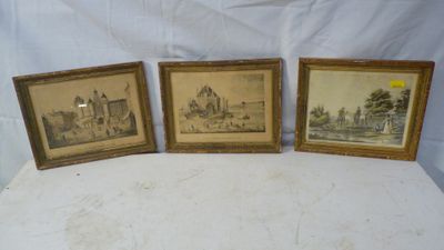 three framed pictures of a castle and a church on a table