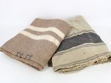trois serviettes sont empilées les unes sur les autres sur une surface blanche
