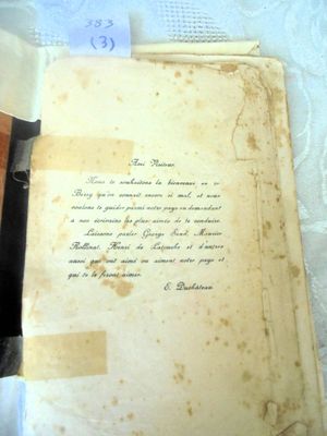 an old book with writing on it sitting on a table