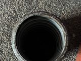 a camera lens sitting on the floor next to a book