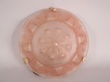 a pink glass plate with a gold rim on a white surface