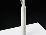 a white vase that is sitting on a table