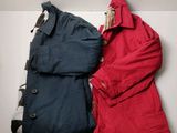 two jackets that are sitting next to each other on a table