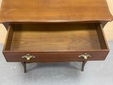 a wooden table with a drawer on top of it