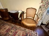 a chair that is next to a table with a book on it