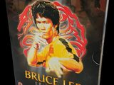 a dvd cover of bruce lee on display on a table
