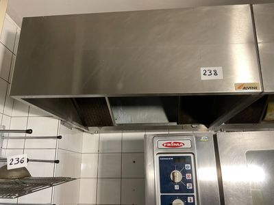 a large stainless steel oven in a kitchen with white tiles on the walls