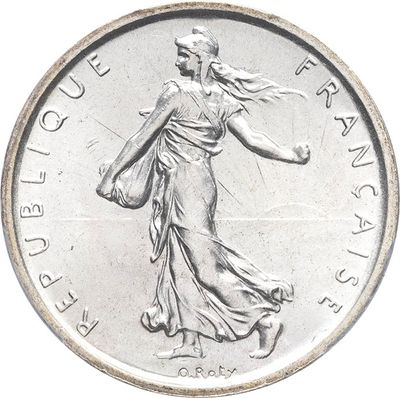 an image of a silver coin with a woman walking on it