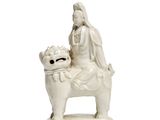 a statue of a woman sitting on a dog