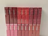 the spines of the books are lined up on a shelf
