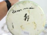a close up of a person holding a plate with writing on it